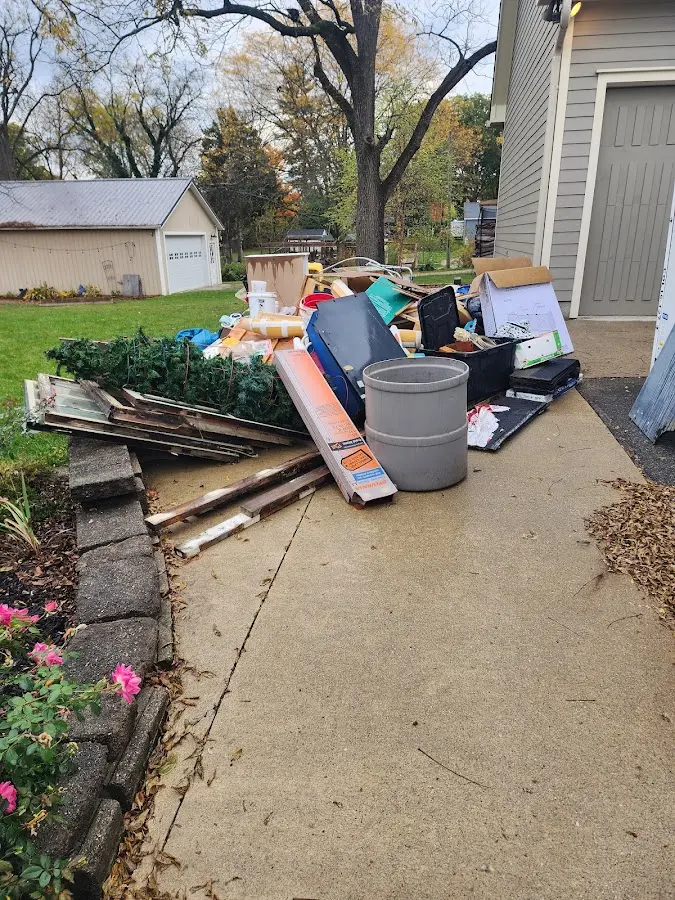 Dumpster being loaded with debris for 12 Yard Dumpster Rental in Lambertville